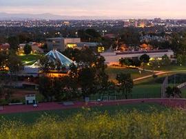 View from French Hill of CU Center, Library, and Grimm Hall at dusk.